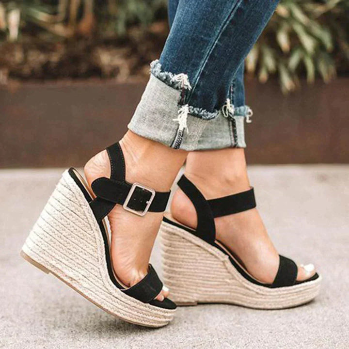 Stylish women's brown espadrille wedge sandals featuring an open toe and secure ankle strap for comfort.