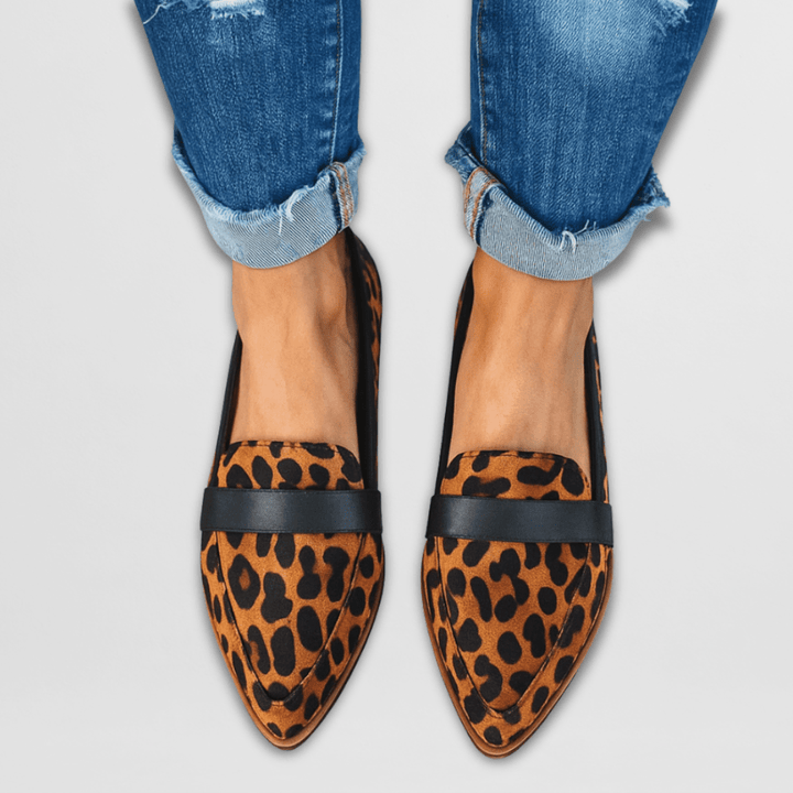 Women's slip-on shoes with a sophisticated pointed toe and decorative penny strap accent