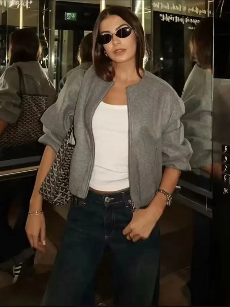 Cropped hemline of a women's lightweight bomber jacket, showcasing its fashionable and versatile design.