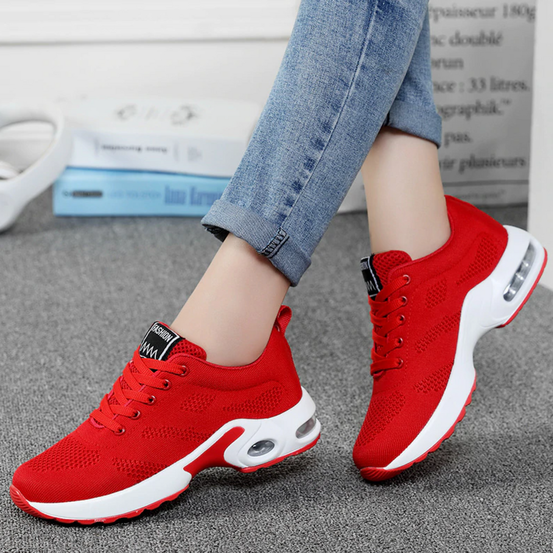 Side view of women's lightweight sneakers with supportive air cushion sole.