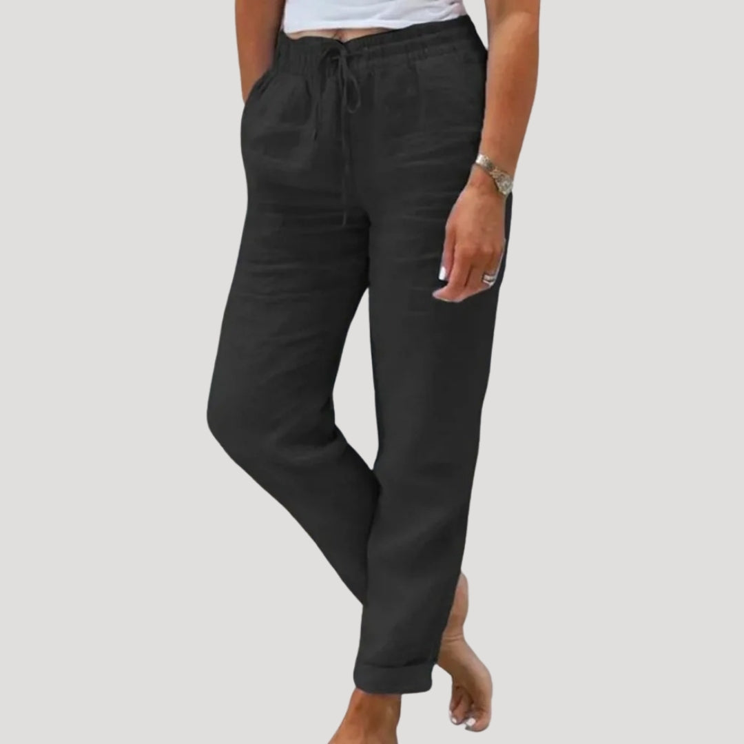 Close-up of women's lightweight linen trousers fabric, showing breathable texture for summer comfort.
