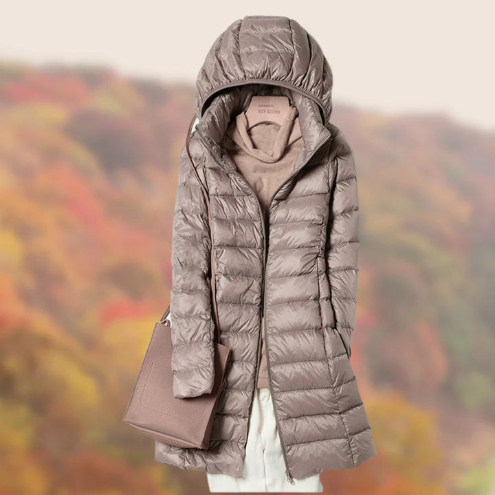 Stylish long winter coat for women, featuring a durable puffer design.