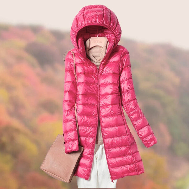 Stay warm in this long, zip-up puffer jacket designed for women.