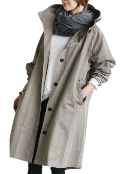 Woman wearing a stylish women's hooded rain jacket for outdoor adventures.