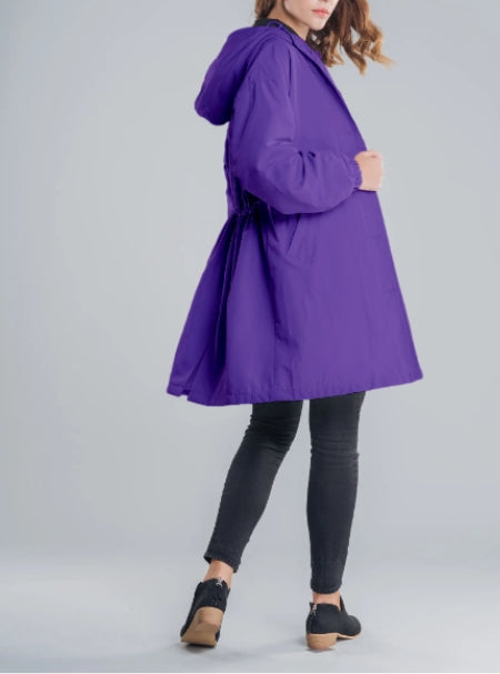 Detail of the zipper and hood on a women's all-weather outdoor jacket.