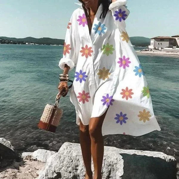 White women's beach cover-up, long sleeve button-down design for stylish sun protection at the beach or resort.
