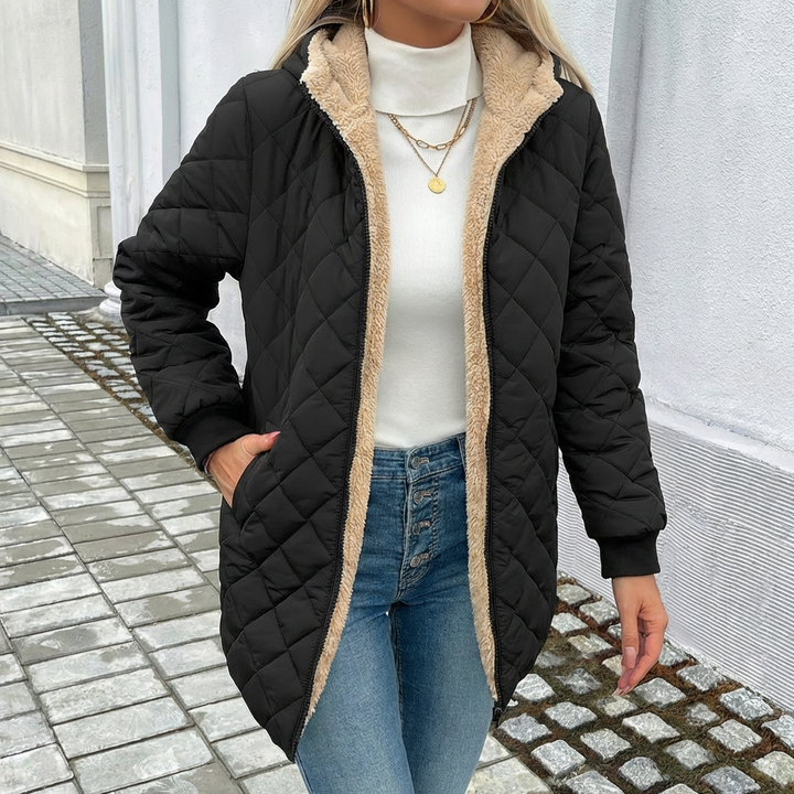 Stylish women's longline quilted coat with hood. Warm outerwear, ideal zip coat for cold weather fashion.