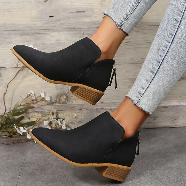 Stylish black women's ankle work boots with a comfortable low heel, perfect for casual wear.