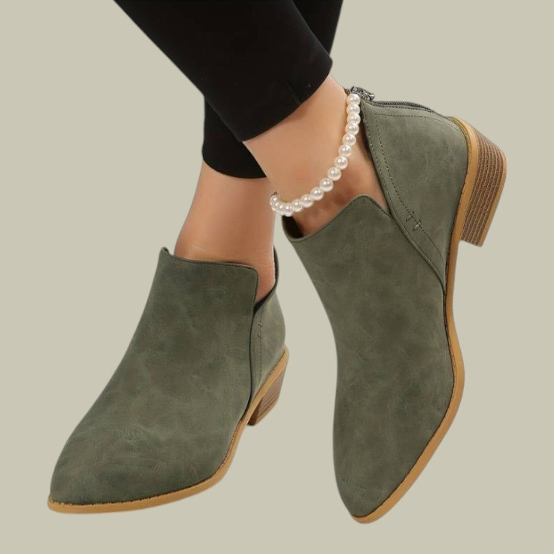 Model wearing comfortable women's ankle work boots with a low heel, ideal for everyday style.
