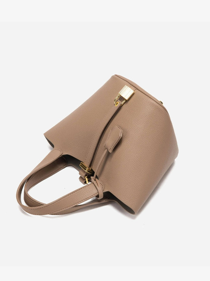 Structured taupe bucket bag with elegant gold hardware for women