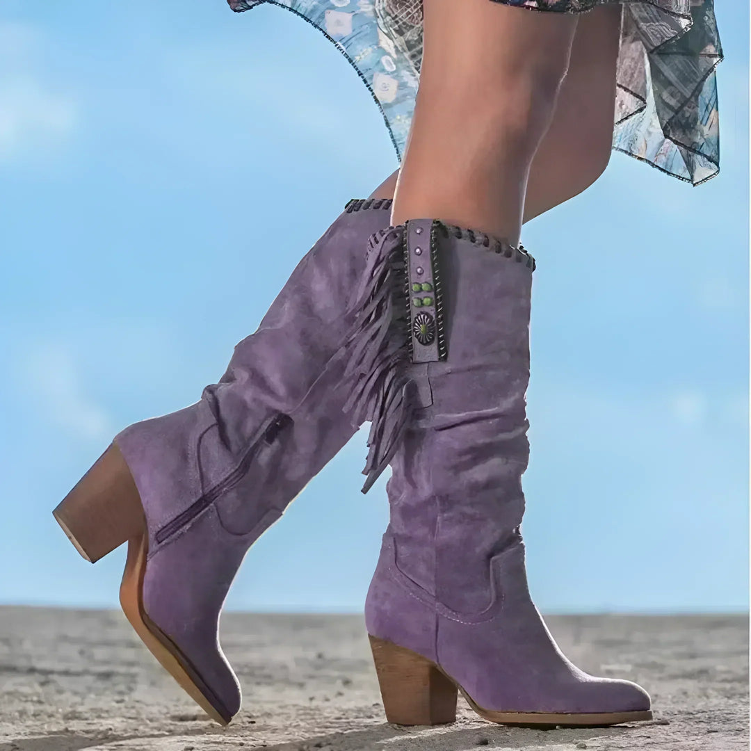 Stylish women's mid-calf cowgirl boots featuring fringe detail & comfortable block heel for casual or festival look.