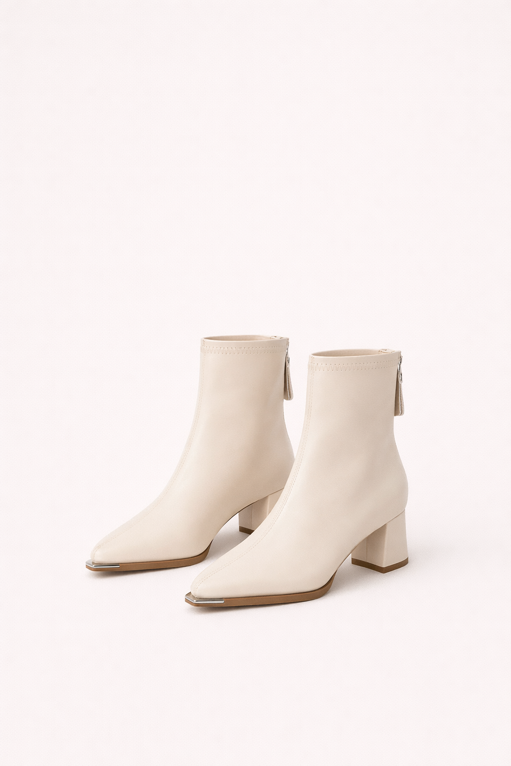 Women's minimalist ankle boots with a chic block heel, perfect for elegant everyday style.
