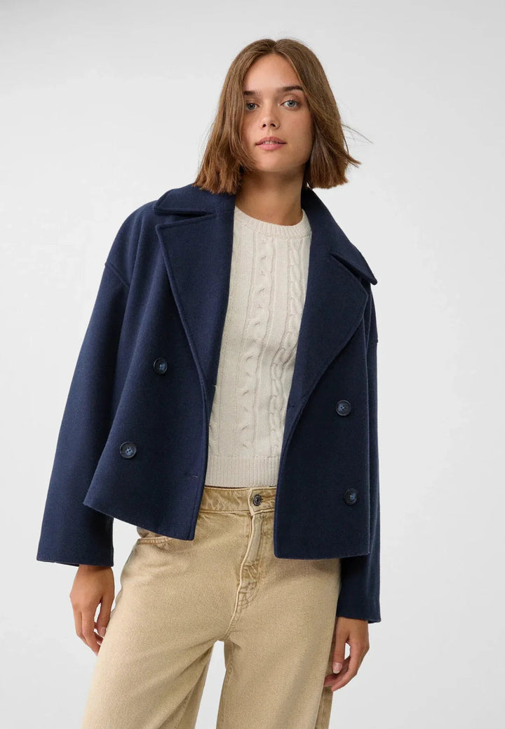 Stylish women's double-breasted short coat, essential fall & winter outerwear for a modern look.
