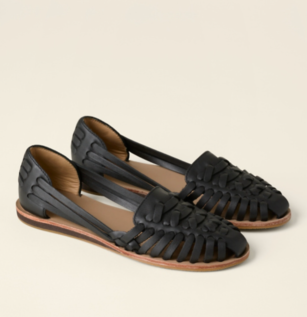 Women's Olivia black closed-toe slip-on sandals with stylish woven detail and flat sole.