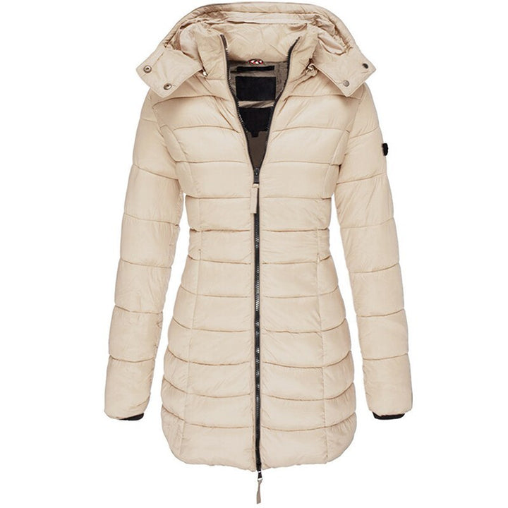 Full-body shot of a woman wearing the Olivia warm hooded jacket outdoors.