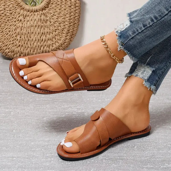 Woman wearing comfortable orthopedic bunion relief sandals for a casual summer walk, promoting foot health.