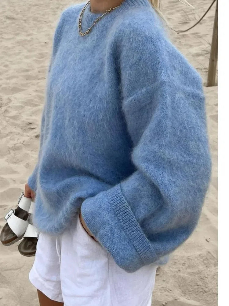 Close-up of the soft knit texture of a blue oversized women's sweater.