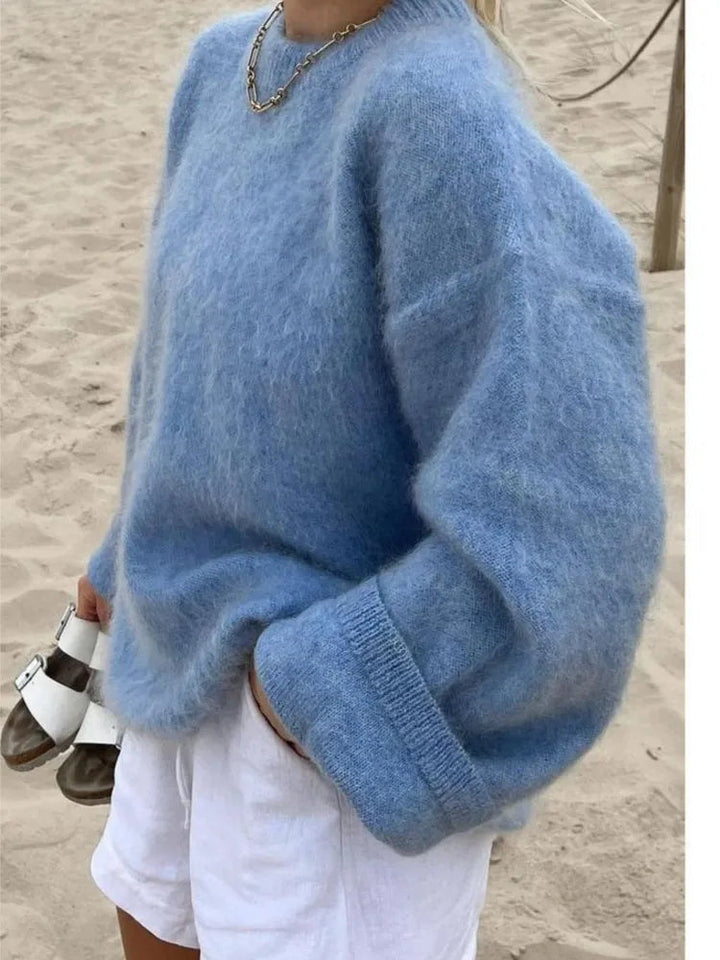 Close-up of the soft knit texture of a blue oversized women's sweater.