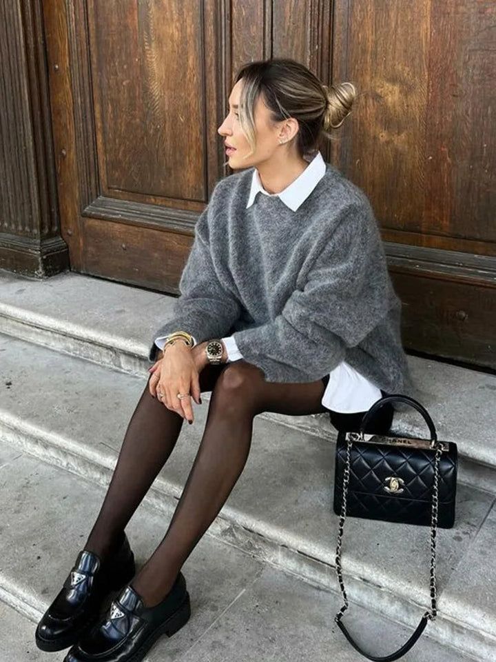 Beige oversized knit sweater for women, highlighting its comfortable and relaxed fit.