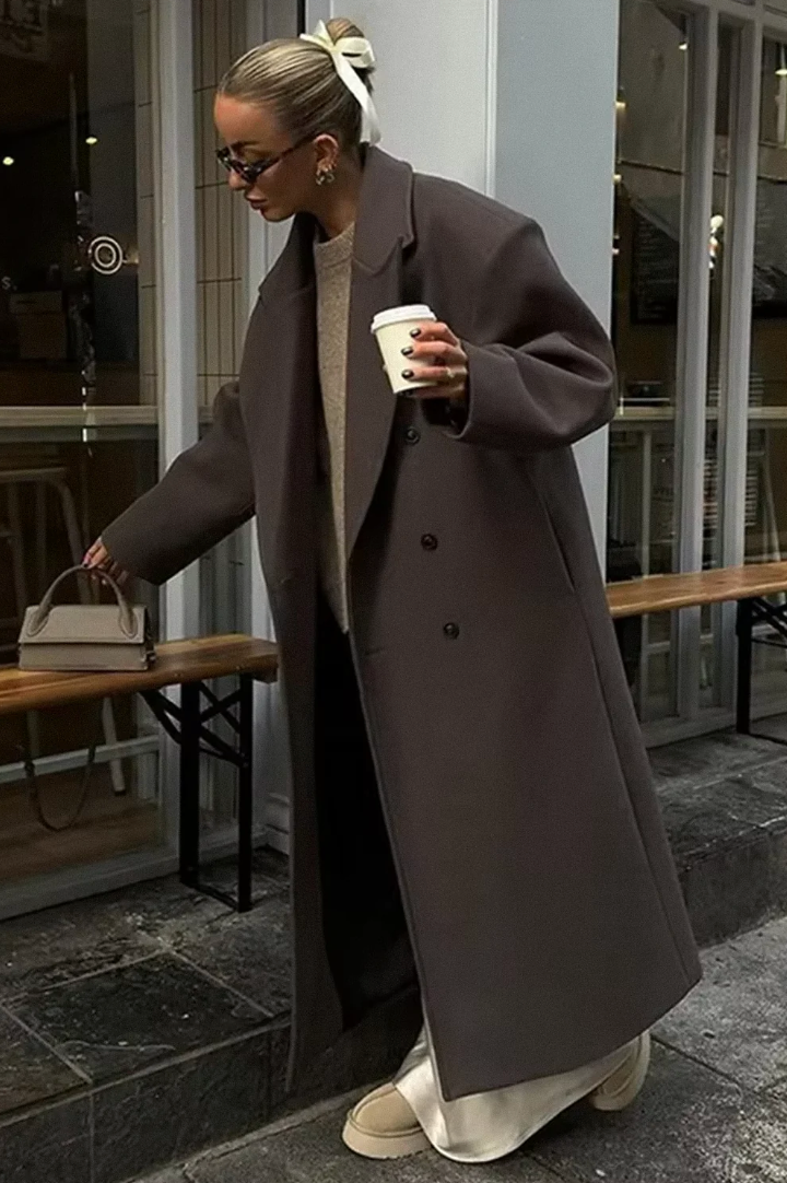 Women's oversized double-breasted longline brown coat for elegant winter fashion and stylish outerwear.