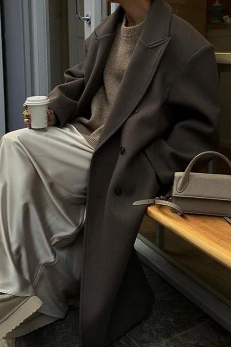 Chic women's oversized double-breasted longline coat, perfect for modern layering and elegant winter style.