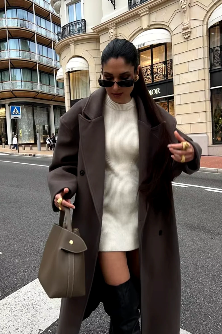 Elegant brown oversized double-breasted coat for women, a chic longline outerwear piece for modern fashion.