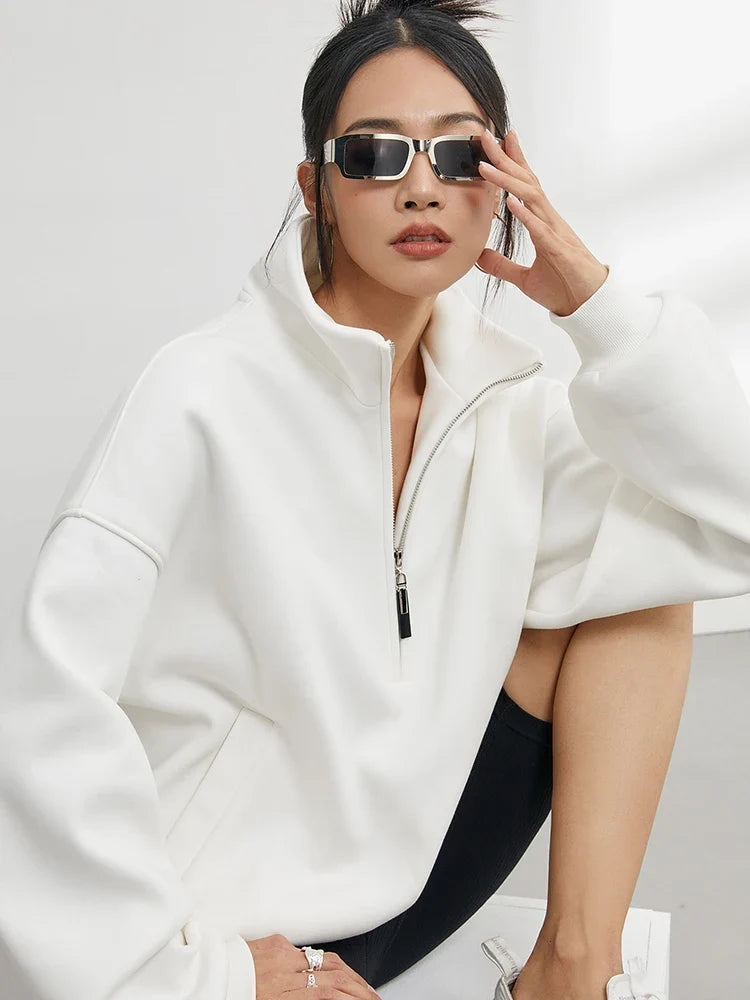 Cozy women's oversized pullover hoodie with half-zip, offering comfortable, relaxed fit for everyday casual wear.