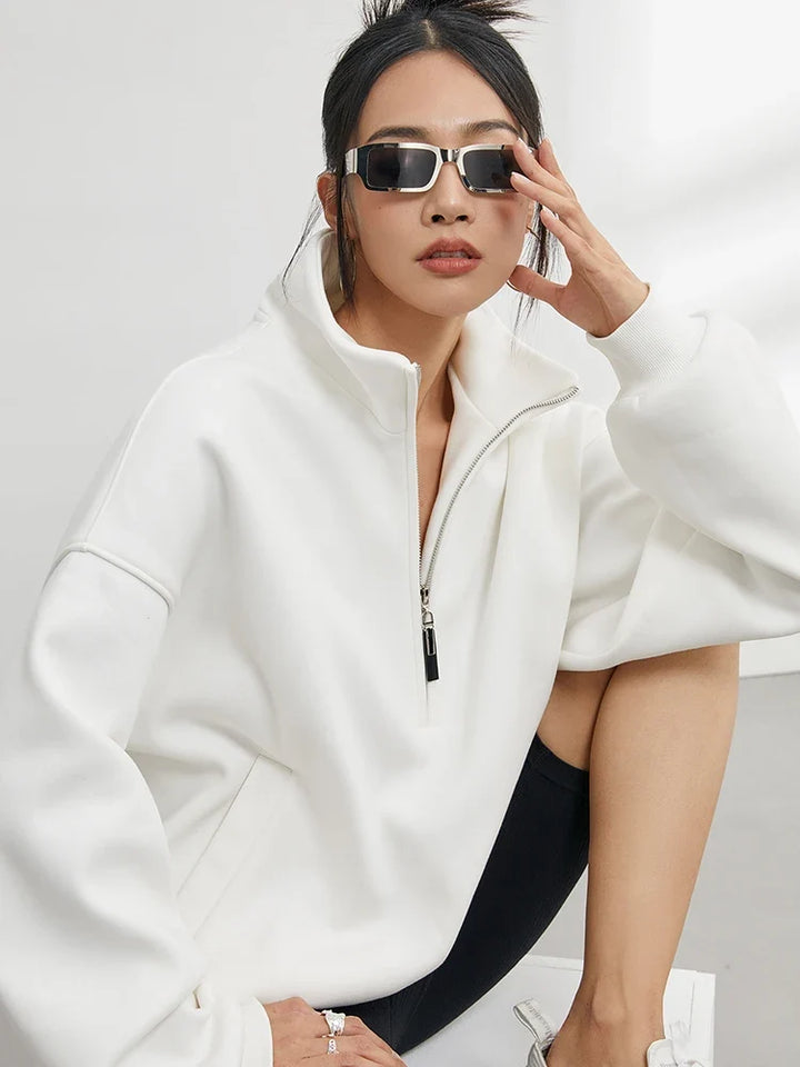 Cozy women's oversized pullover hoodie with half-zip, offering comfortable, relaxed fit for everyday casual wear.