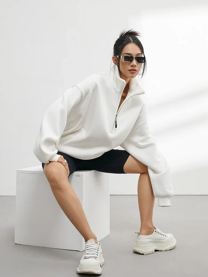 Relaxed fit women's oversized hoodie featuring a half-zip neckline, perfect for casual winter and loungewear.
