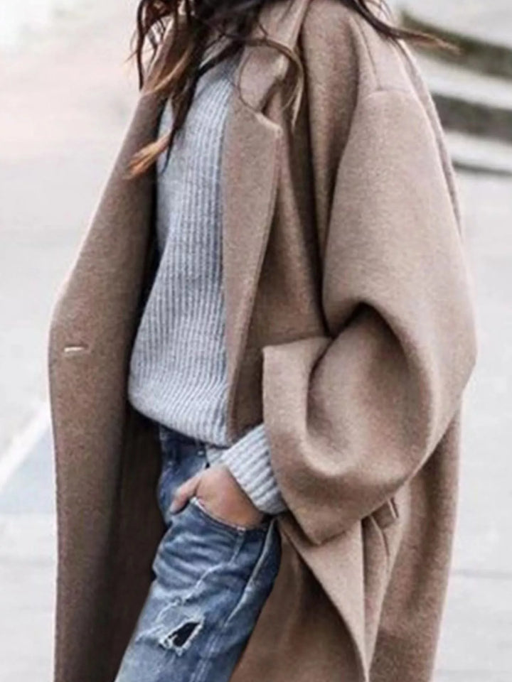 Fashion outerwear: a stylish women's long trench coat with oversized lapel detail.
