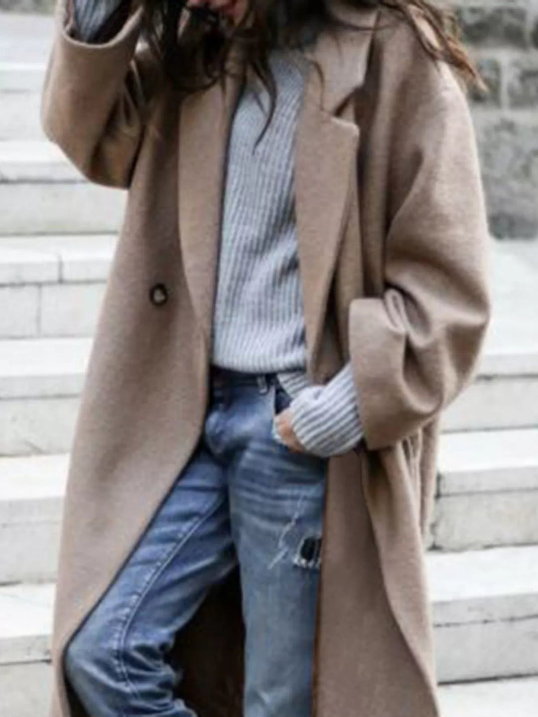 Chic women's long trench coat featuring an oversized lapel and relaxed fit.