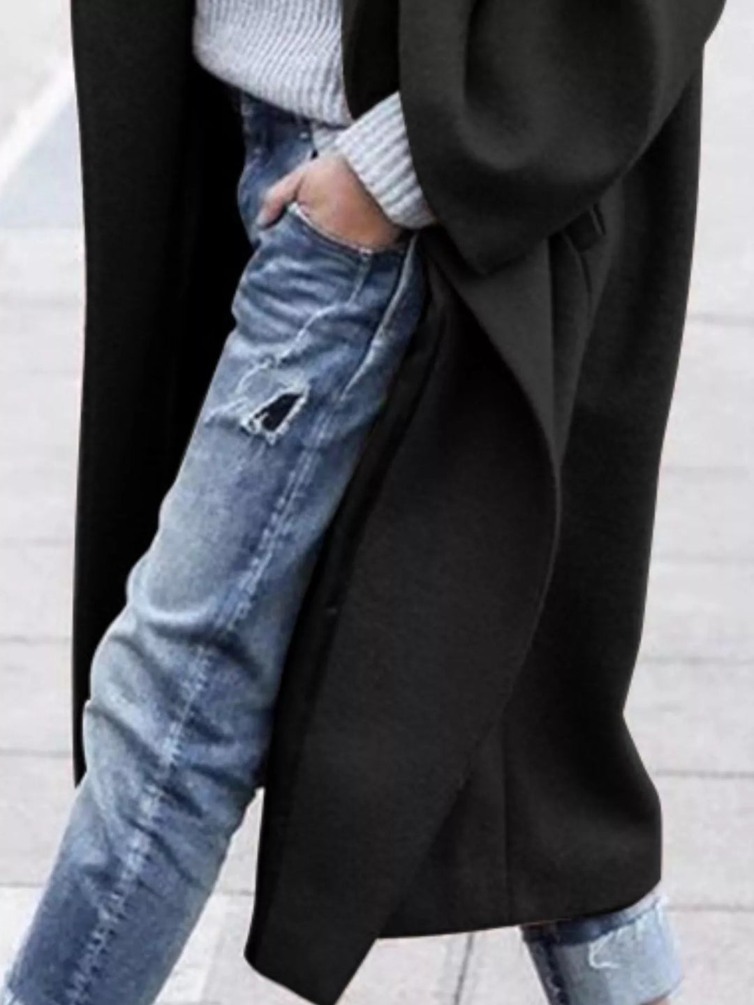 Showcasing the oversized lapel on a women's long fashion trench coat.