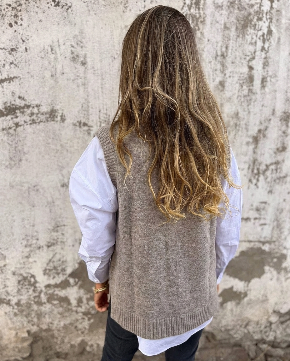 Comfortable black oversized V-neck sweater vest, a soft knitted women's top for versatile everyday layering.