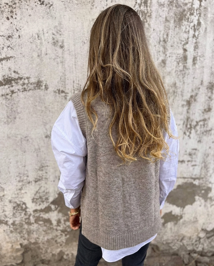Comfortable black oversized V-neck sweater vest, a soft knitted women's top for versatile everyday layering.