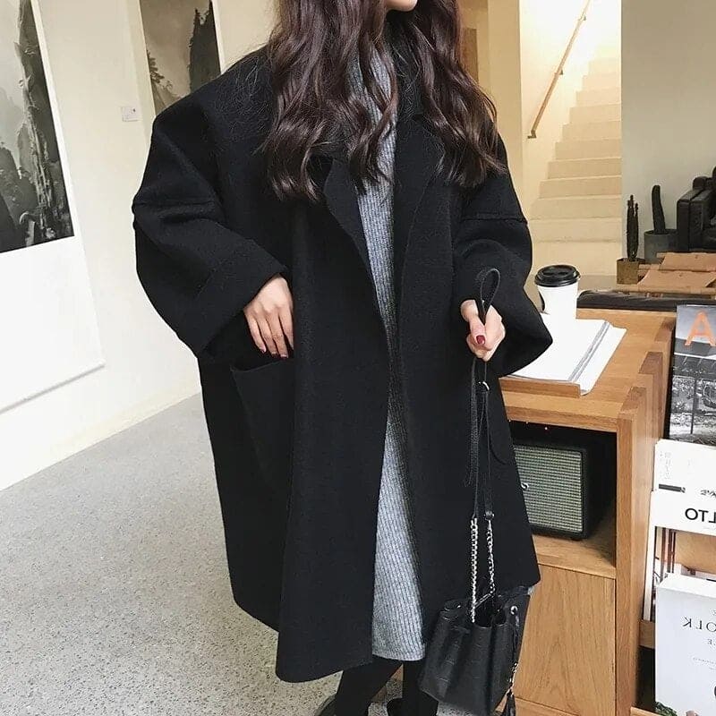 Luxurious women's oversized wool blend trench coat. Long, elegant, and stylish with a belted silhouette.