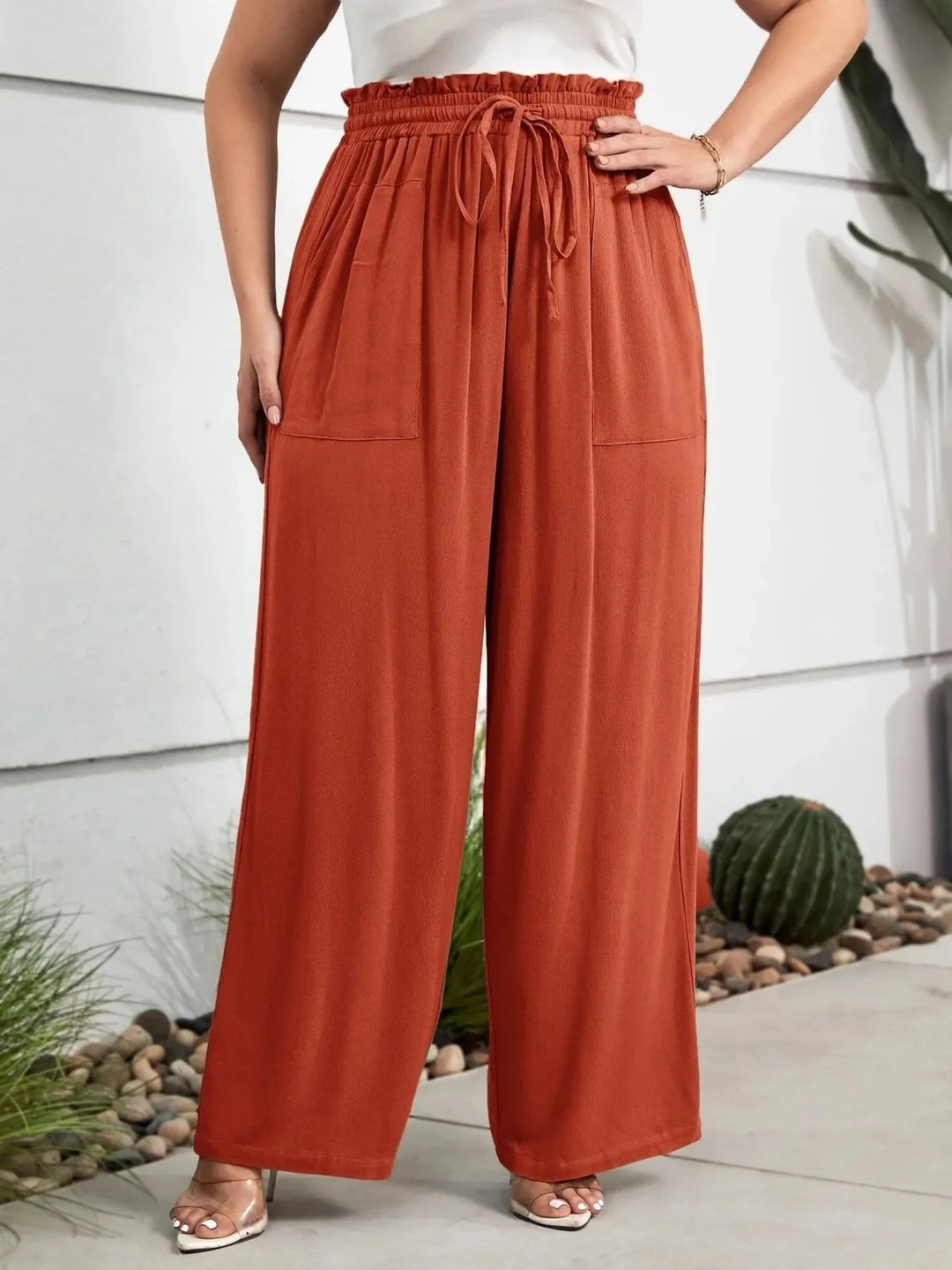 Plus size casual pants featuring a flattering paperbag waist and wide leg silhouette