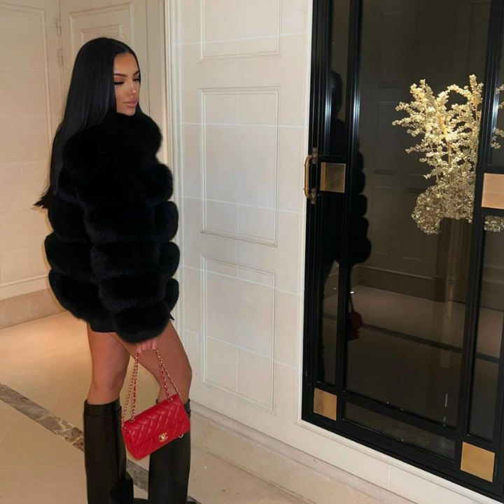 Elegant women's winter jacket crafted from plush faux fur, offering ultimate cozy fashion.