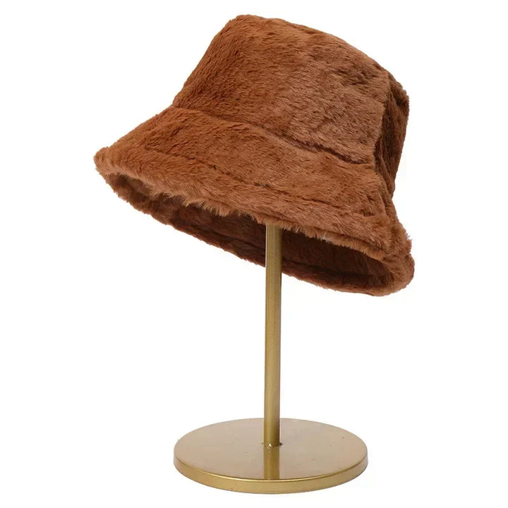 Chic women's faux fur bucket hat, offering warmth and a trendy look for colder seasons.