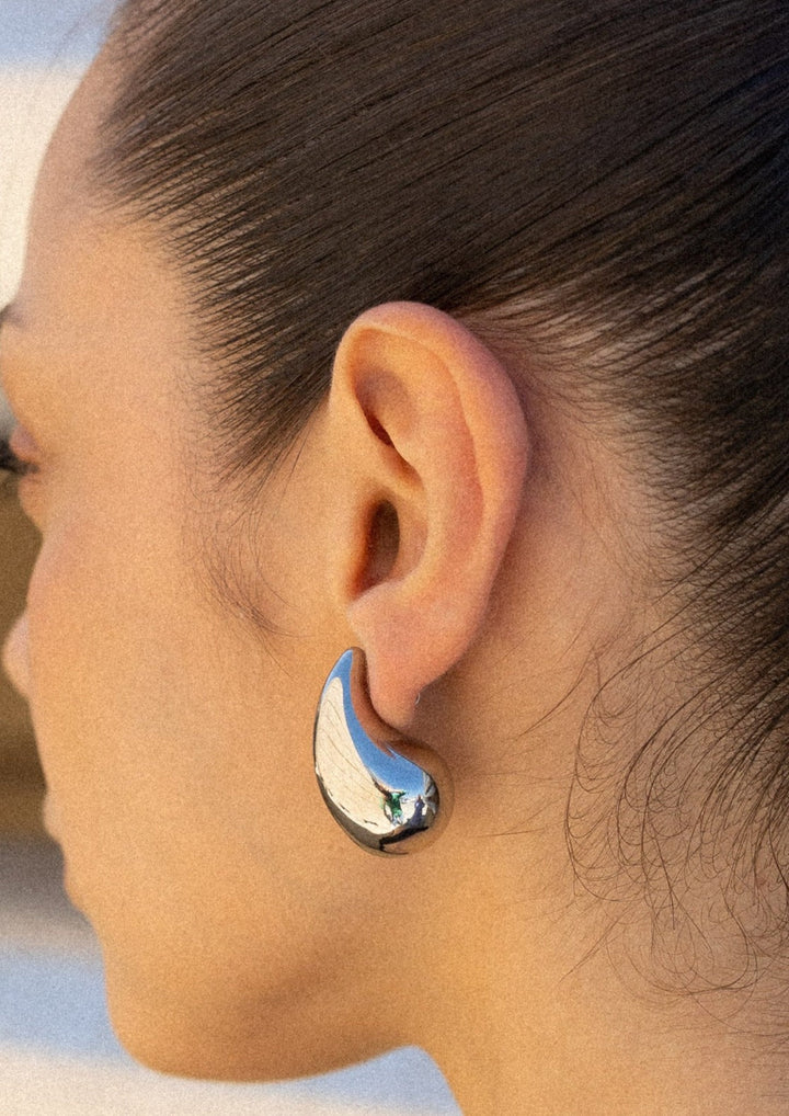 Shimmering gold polished teardrop dangle earrings, women's fashion jewellery.