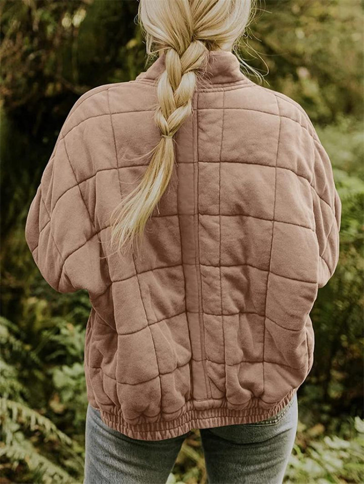 Modern women's quilted zip-front jacket, ideal for casual layering, featuring a stylish stand collar.