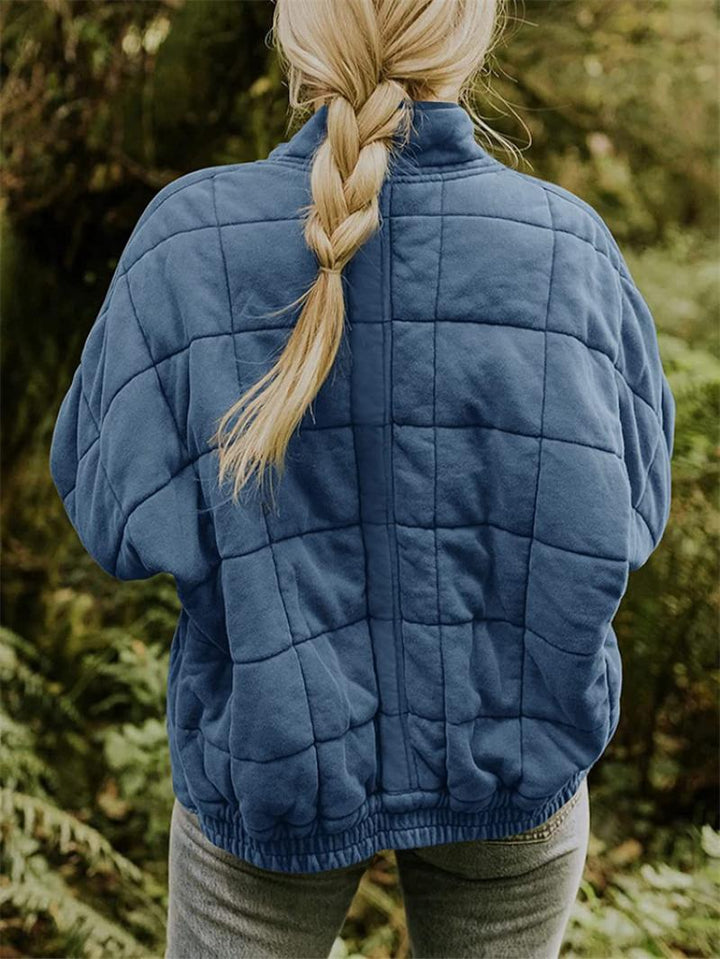 Women's quilted zip-front casual jacket. Stylish outerwear with a stand collar for layering.