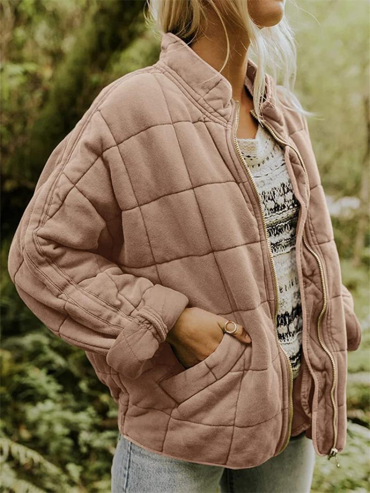 Textured women's quilted zip-front jacket, a stylish & cozy casual layering piece with stand collar.