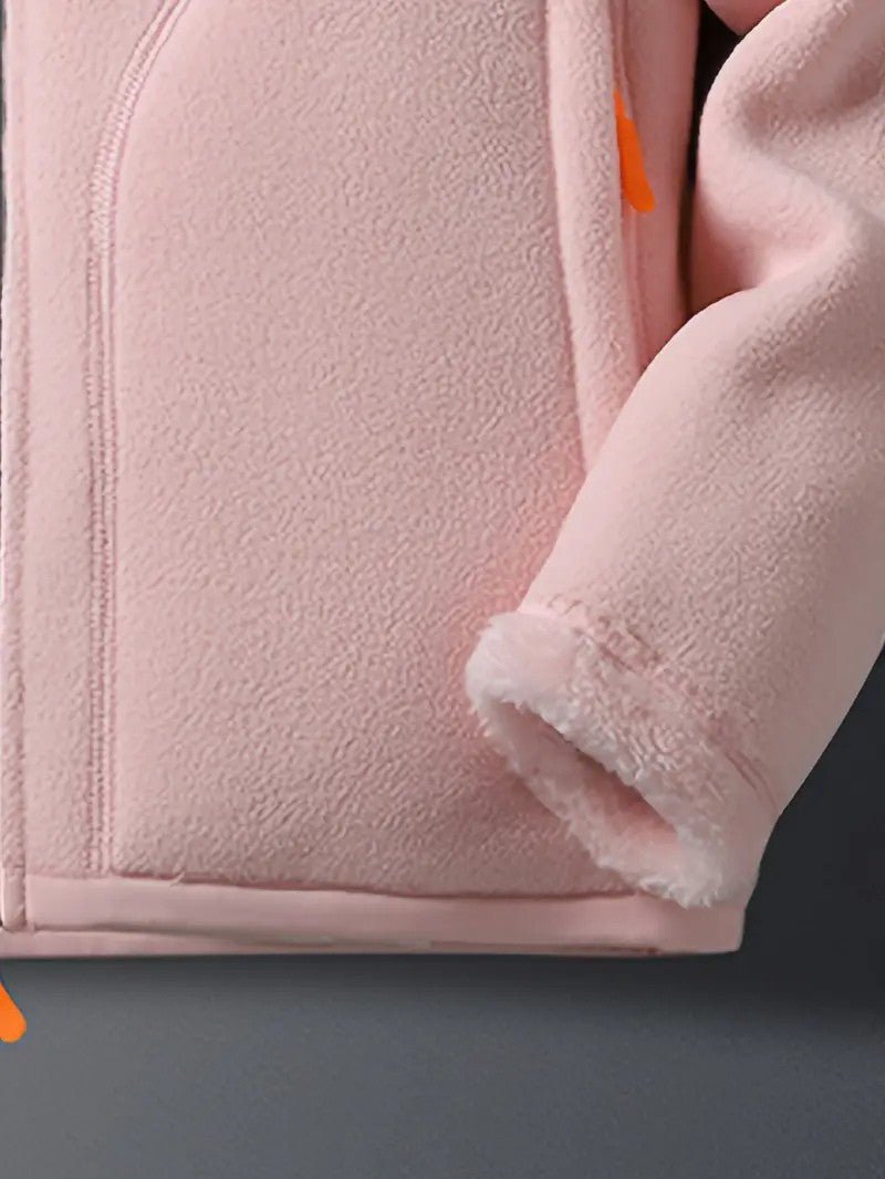 Close-up of a women's cozy reversible winter jacket, showing stand collar and soft fabric detail.