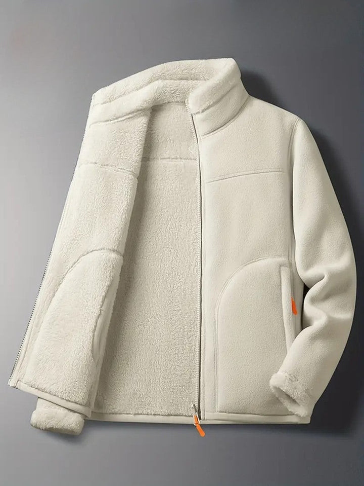 Full shot of a woman wearing the pink reversible winter jacket, styled for cool weather comfort.
