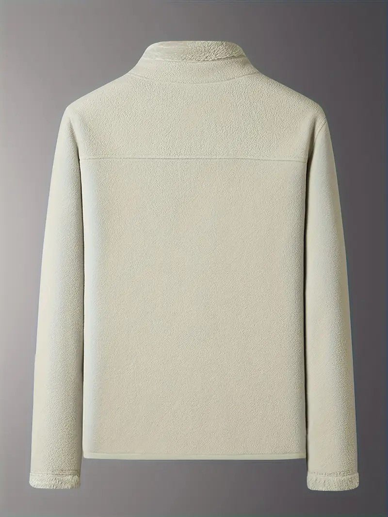 Folded women's reversible winter jacket in pink/ivory, showcasing its compact, cozy design.