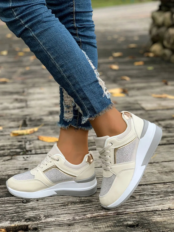 Close-up of dazzling rhinestone embellishments on women's platform sneakers.
