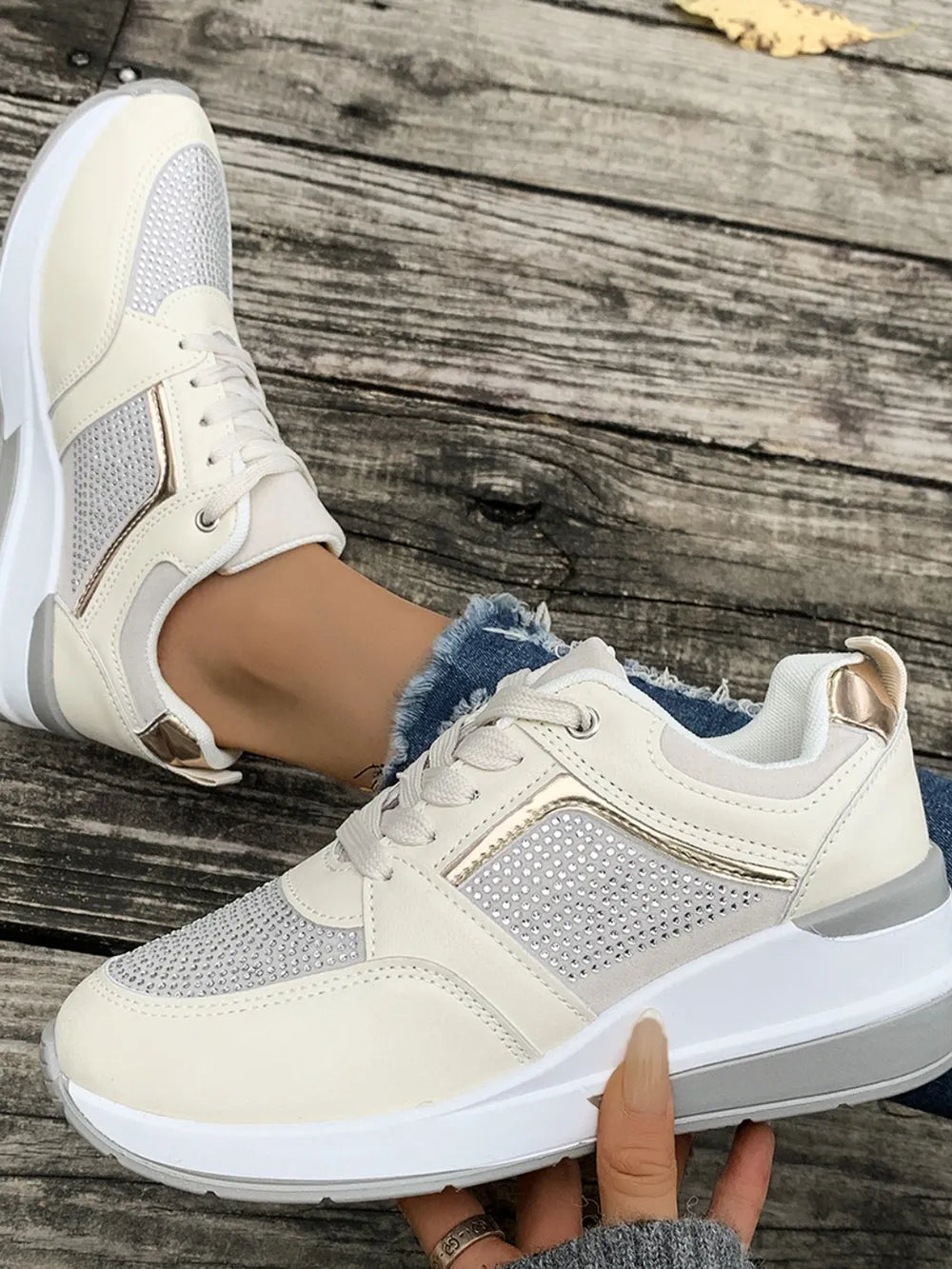 Fashionable women's platform sneakers adorned with shiny rhinestones, perfect for casual outings.