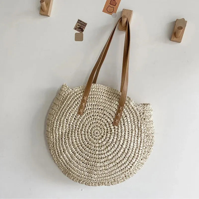 Elegant women's round woven tote, ideal as a beach bag, summer shoulder bag, natural style.