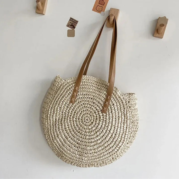 Elegant women's round woven tote, ideal as a beach bag, summer shoulder bag, natural style.