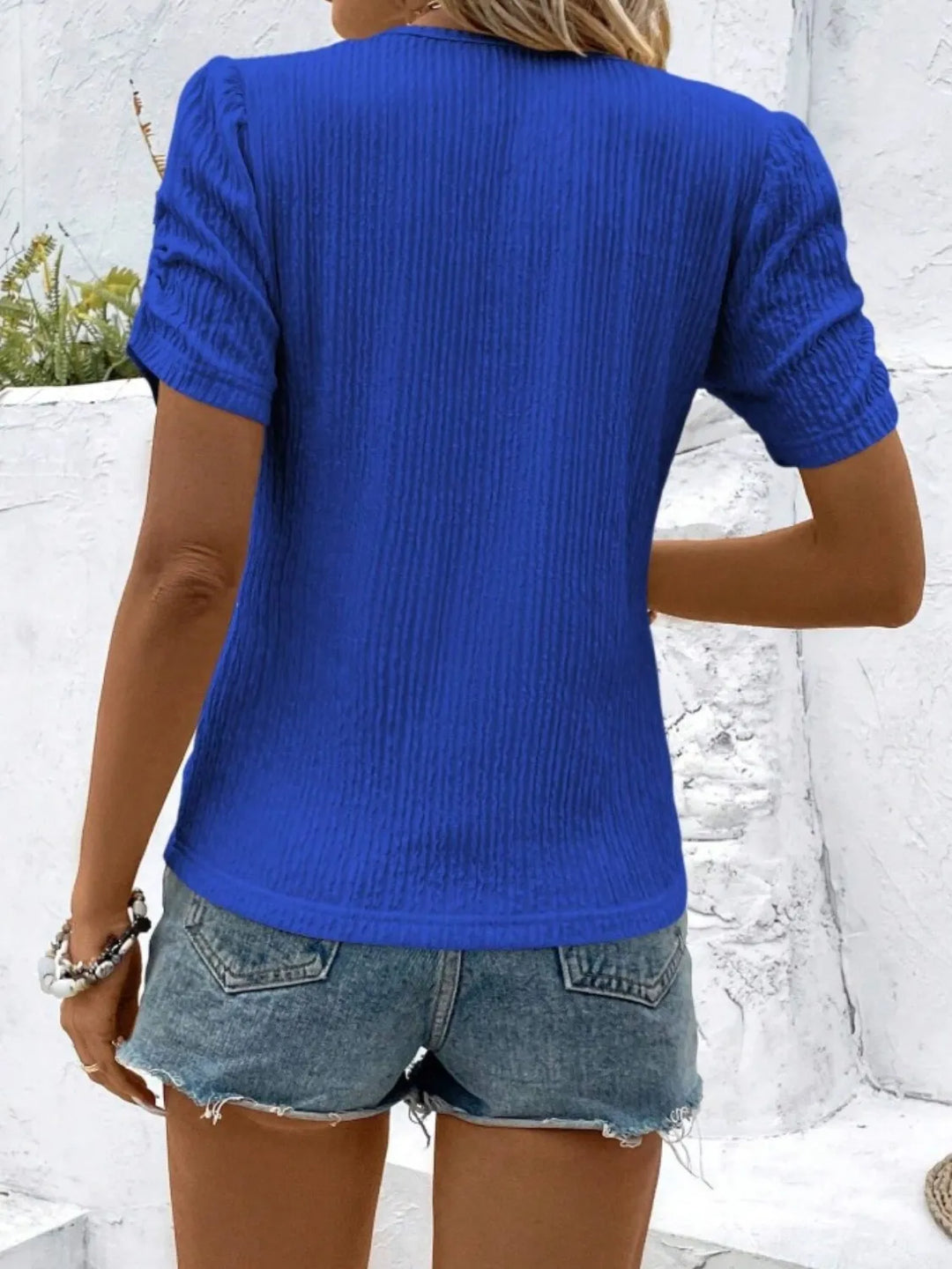 Elegant women's short sleeve top with subtle ruched detailing